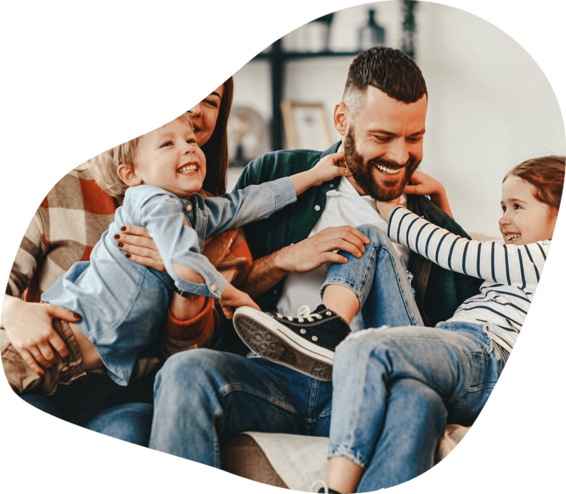 Father playing with two children at home